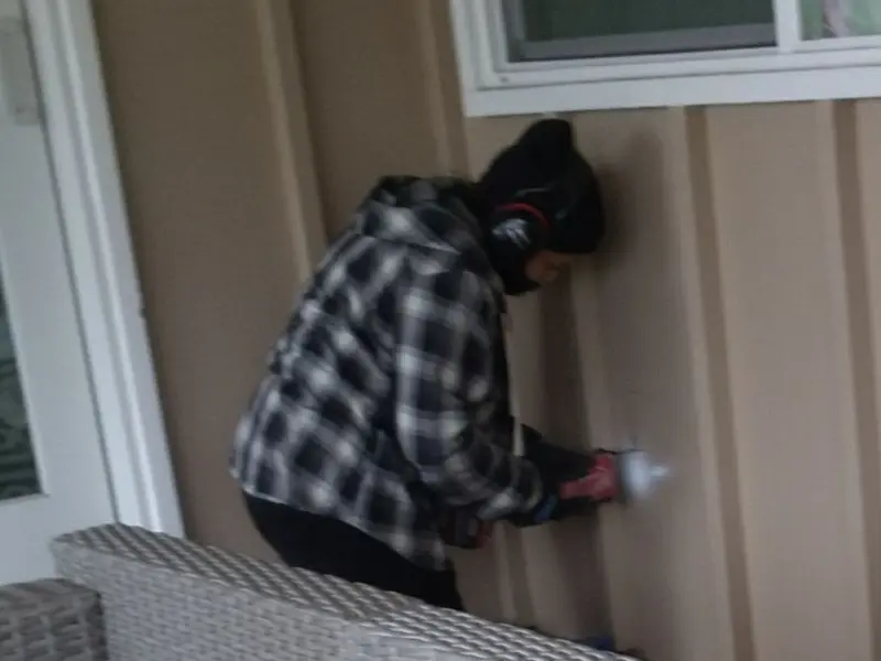 Professional electrician installing an exterior outlet in Swartz