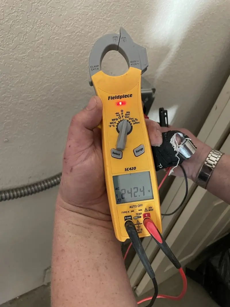 Voltage testing with clamp meter during Recessed Lighting Installation in Swartz